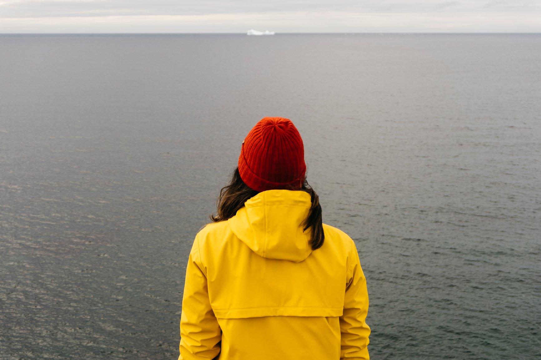 woman looking at ocean iceberg