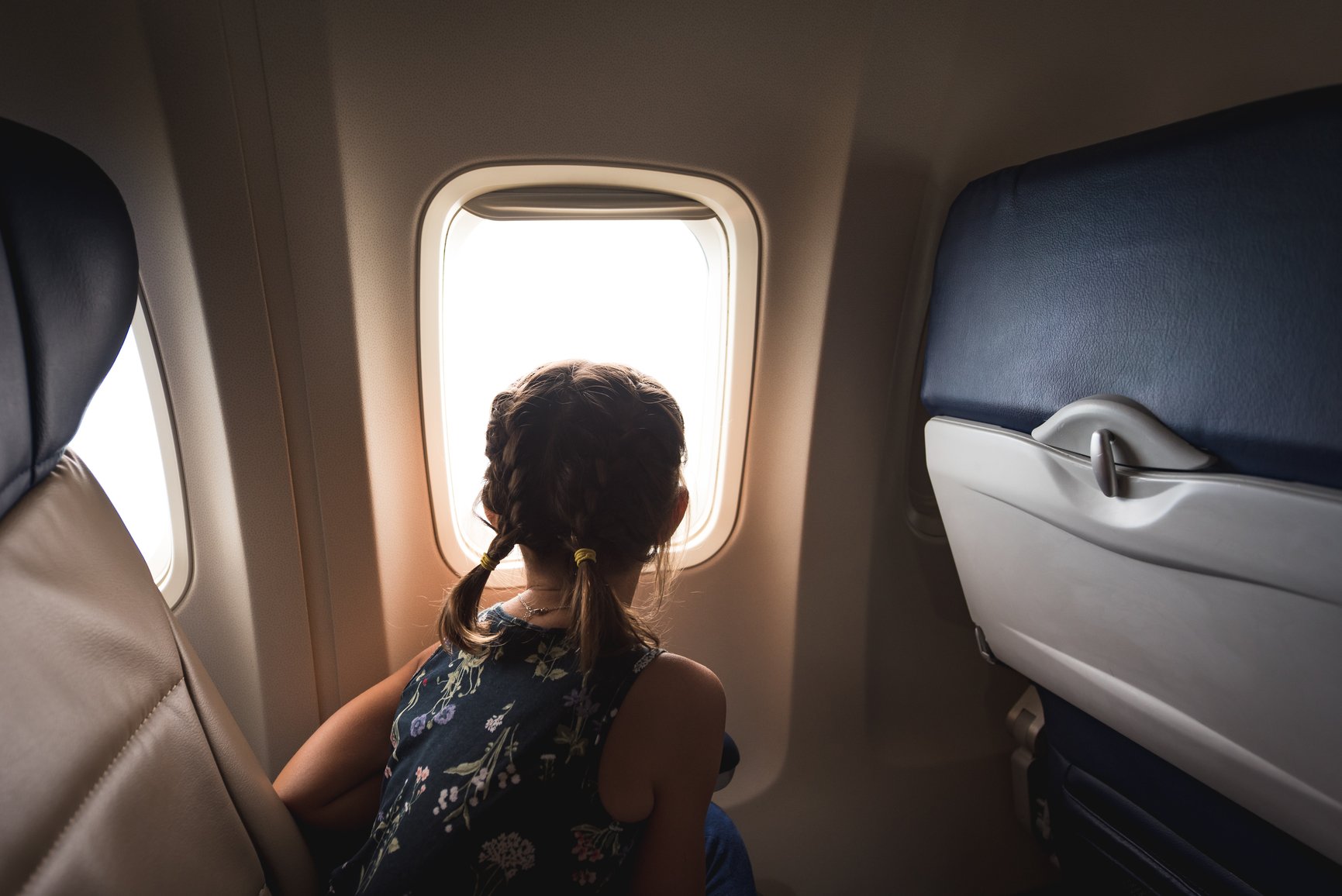 Girl looking out an airplane