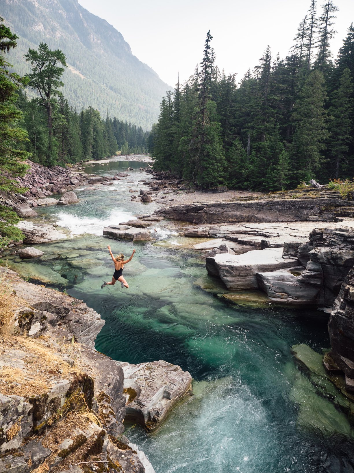 woman jumping into river