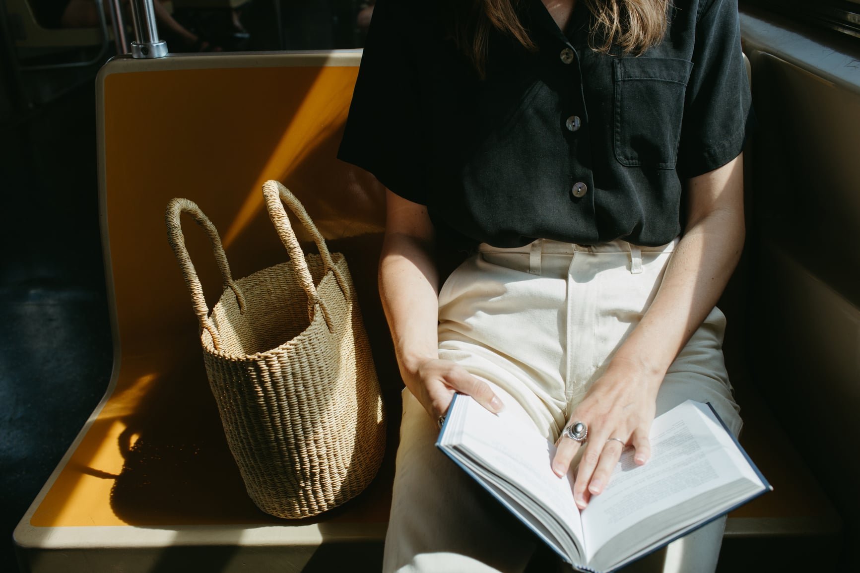 Woman Reading on a Subway